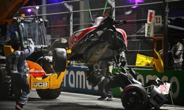 Track marshals clean debris from the track following Mick Schumacher's crash during qualifying ahead of the F1 Grand Prix of Saudi Arabia at the Jeddah Corniche Circuit on March 26