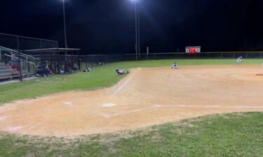 Players drop to the ground as gunfire is heard during a youth baseball game in North Charleston