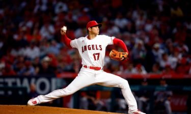 Ohtani throws against the Astros at Angel Stadium on Opening Day. The 27-year-old made history as he became the first player in the history of the American and National Leagues to throw his team's first pitch of the season and face his team's first pitch as a hitter.