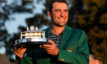 Scottie Scheffler holds the championship trophy after winning the 86th Masters on April 10.