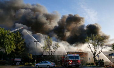 Firefighters work on a five-alarm fire at the Home Depot in San Jose