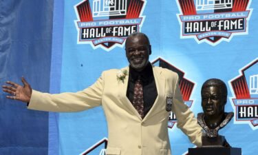Rayfield Wright of the Dallas Cowboys poses with his bust after his induction during the Class of 2006 Pro Football Hall of Fame Enshrinement Ceremony.