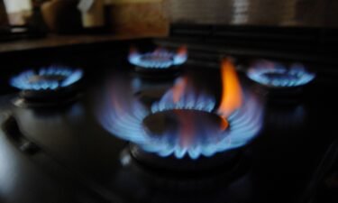 Britons are paying 54% more for their energy starting now. Gas burns on a gas home cooker in a kitchen in London