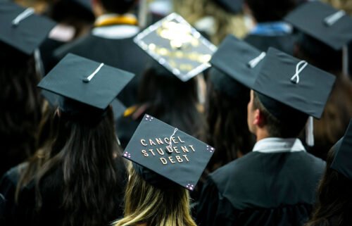 A University of Iowa graduate wears a cap with the words "Cancel student debt" during a commencement ceremony in Iowa City on May 14.