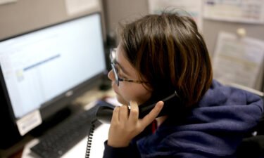 A volunteer at the Samaritans Call Center takes a call at the office in Boston on February 28