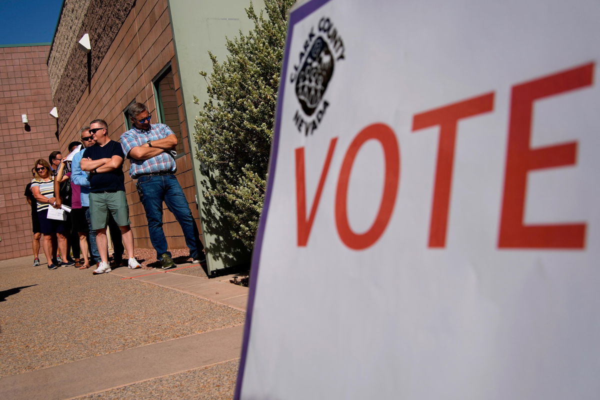 <i>John Locher/AP</i><br/>People wait in line to vote on Tuesday