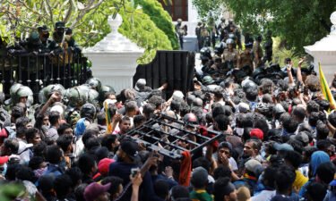 Demonstrators carry the gate to Sri Lanka's Prime Minister Ranil Wickremesinghe's office premises