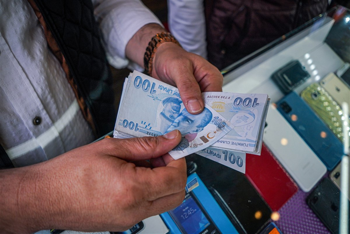 <i>Tunahan Turhan/SOPA Images/LightRocket/Getty Images</i><br/>Inflation soars to nearly 80% in Turkey as food prices double. A man here counts Turkish money in his hands.
