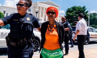 Rep. Ilhan Omar is escorted away from a sit-it outside of the Supreme Court with members of Congress to protest the decision to overturn Roe v. Wade on July 19.
