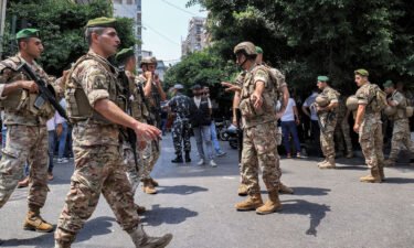 Army soldiers gather near a bank in Beirut