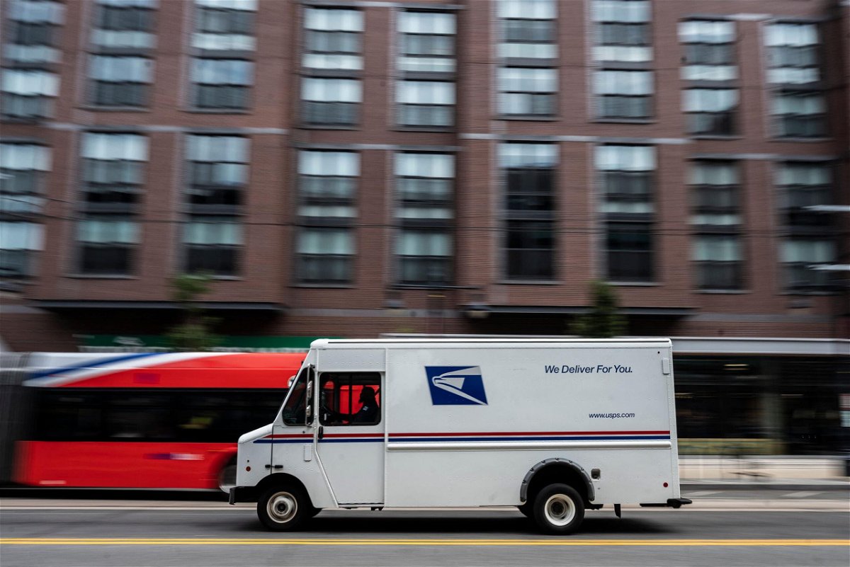 <i>Andrew Caballero-Reynolds/AFP/Getty Images</i><br/>A postman drives a United States Postal service (USPS) mail delivery truck through Washington