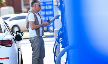 A customer uses a credit card before they pump gas at a Mobil gas station on April 28