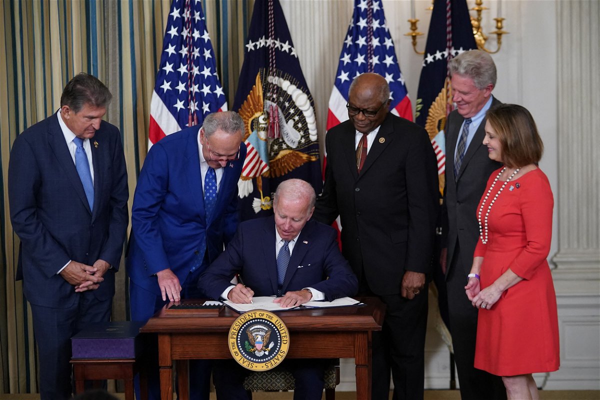 <i>Mandel Ngan/AFP/Getty Images</i><br/>President Joe Biden signs into law the Inflation Reduction Act of 2022 during a ceremony in the State Dining Room of the White House in Washington