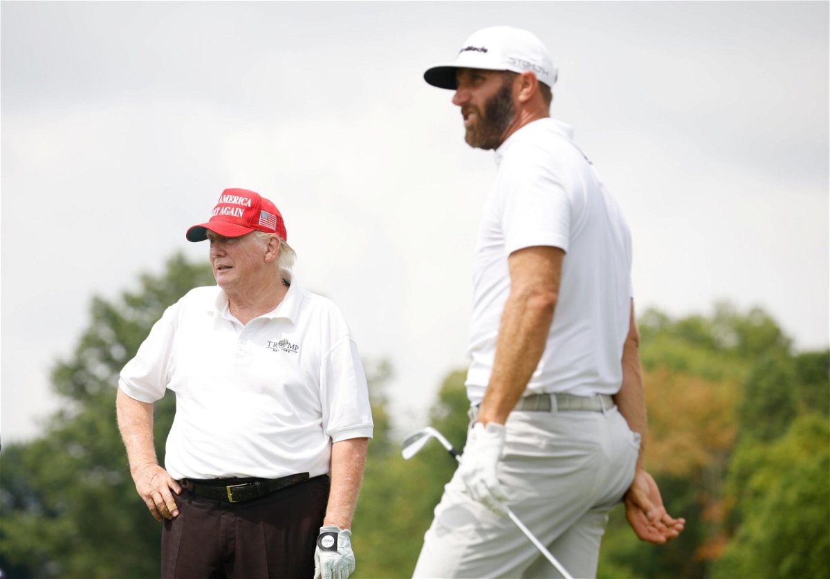 <i>Cliff Hawkins/Getty Images</i><br/>Trump looks on as Johnson plays a shot from the seventh tee during Thursday's pro-am.