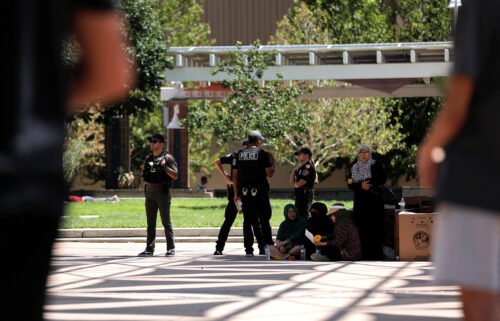 Members of the Albuquerque Police Department standby during a unity event following the murders of four Muslim men in Albuquerque