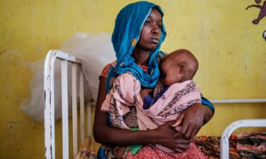 The world is moving backward in the combat against poverty and disease. A woman is seen here holding a malnourished child at the nutrition unit of the Kelafo Health Center in the town of Kelafo