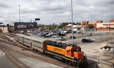 A BNSF engine pull Metra commuter train cars at the Metra/BNSF railroad yard outside of downtown on September 13 in Chicago
