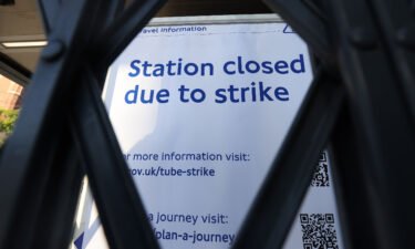 A sign can be seen through a gate at King's Cross St. Pancras underground station in London