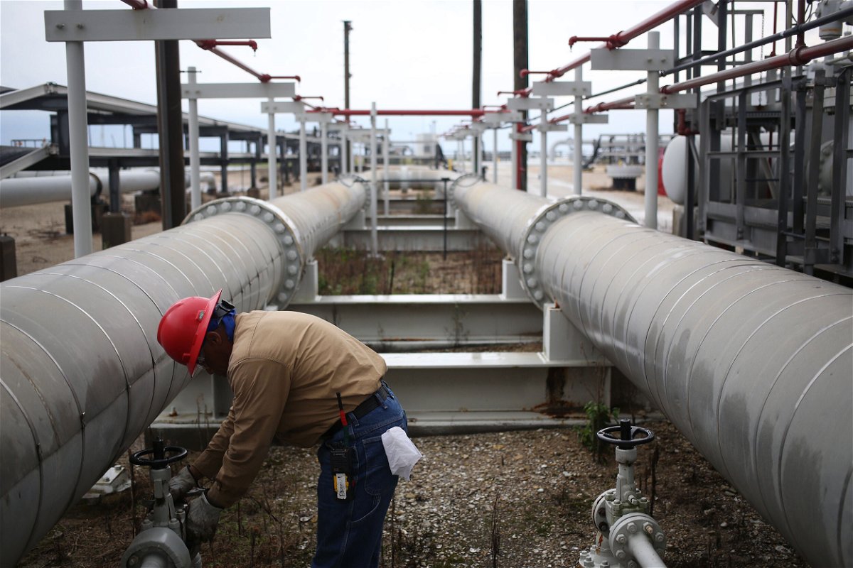 <i>Luke Sharrett/Bloomberg/Getty Images</i><br/>A group of Democrats in Congress is calling on President Joe Biden to keep releasing oil from America's emergency stockpile through at least the end of the year. A contractor is seen here working on a crude oil pipeline infrastructure.