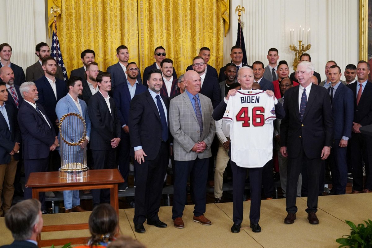 <i>Mandel Ngan/AFP/Getty Images</i><br/>US President Joe Biden holds a jersey presented to him during an event in honor of the 2021 World Series champions the Atlanta Braves at the White House on September 26.