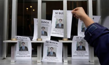 A demonstrator places a flyer outside Peru's Foreign Ministry building in Lima on August 26.