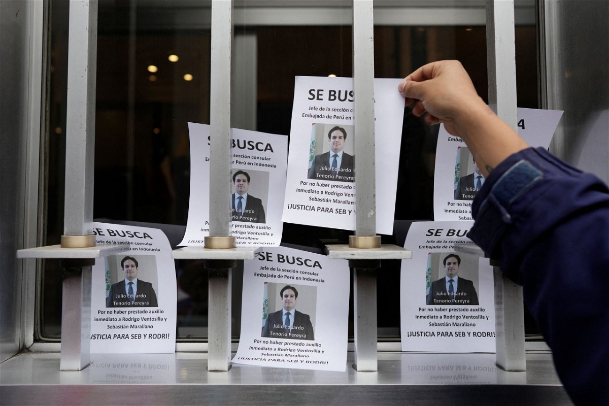<i>Angel Ponce/Reuters</i><br/>A demonstrator places a flyer outside Peru's Foreign Ministry building in Lima on August 26.