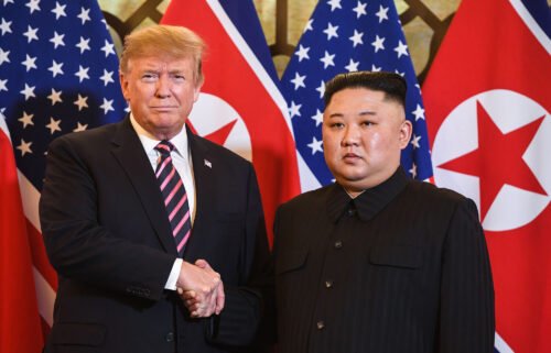 Then-President Donald Trump shakes hands with North Korea's leader Kim Jong Un before a meeting at the Sofitel Legend Metropole hotel in Hanoi on February 27
