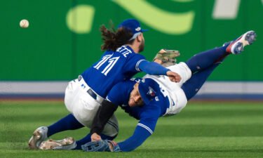 Toronto Blue Jays shortstop Bo Bichette (11) and Toronto Blue Jays center fielder George Springer collide while trying to catch a short fly ball during the eighth inning of Game 2 of a baseball AL wild-card playoff series Saturday