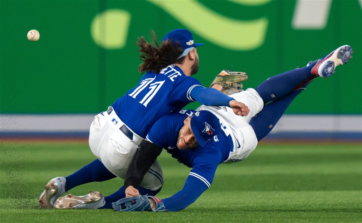 <i>Frank Gunn/The Canadian Press/AP</i><br/>Toronto Blue Jays shortstop Bo Bichette (11) and Toronto Blue Jays center fielder George Springer collide while trying to catch a short fly ball during the eighth inning of Game 2 of a baseball AL wild-card playoff series Saturday