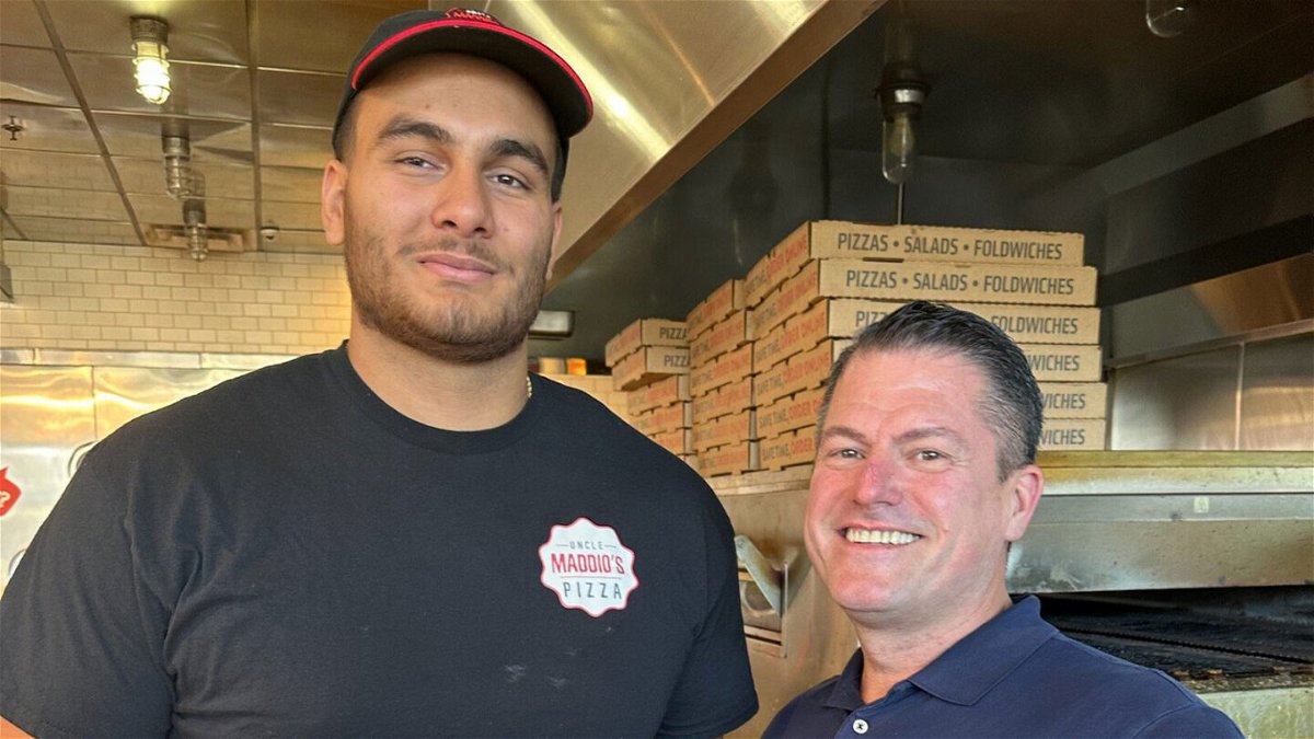 <i>Courtesy Losson Leonard</i><br/>Gutierrez (left) poses with restaurant owner Losson Leonard prior to joining the Patriots' practice squad.