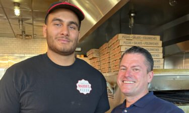 Gutierrez (left) poses with restaurant owner Losson Leonard prior to joining the Patriots' practice squad.