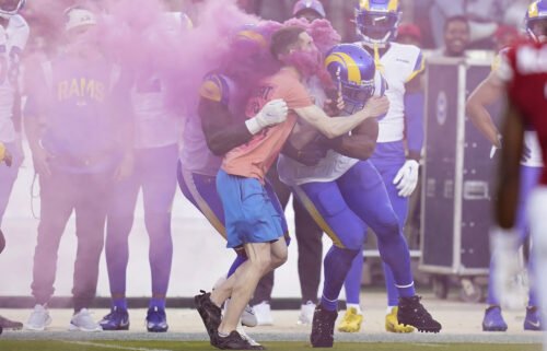 A protester is hit by Los Angeles Rams defensive end Takkarist McKinley
