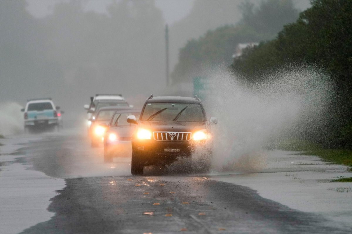 <i>Mark Baker/AP</i><br/>Cars drive through flood waters in Richmond on the outskirts of Sydney