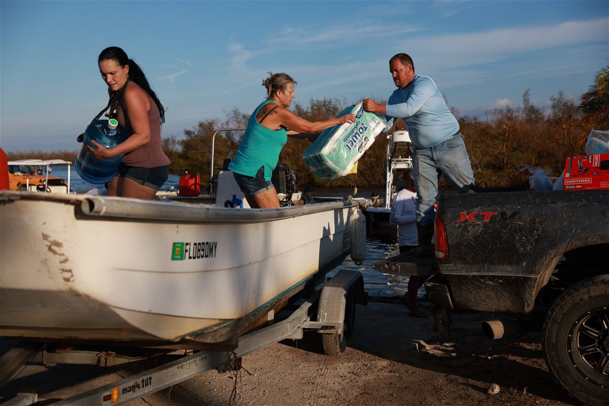 <i>Joe Raedle/Getty Images</i><br/>People load supplies onto a boat in Matlacha
