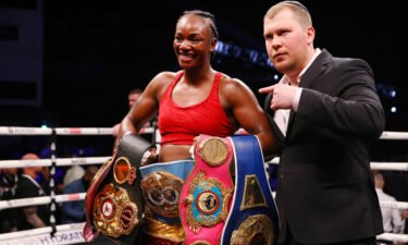 Claressa Shields celebrates victory with her belts after the WBO