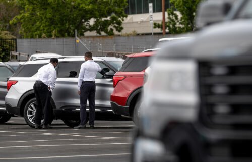 Customers view a vehicle for sale at a Ford Motor Co. dealership in Richmond