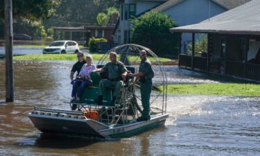 Osceloa County Sheriffs use a fanboat to rescue a 93-year-old resident from flooding on September 30 in Kissimmee
