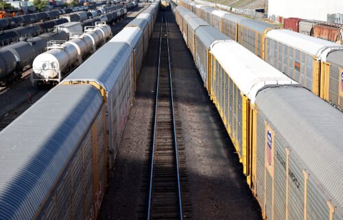 Over 400 business groups plead with Congress to prevent a rail strike. Freight rail cars sit in a rail yard on November 22