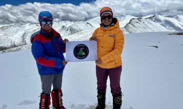 Malavath and Manyapu hold up their Project Shakthi logo at the summit.