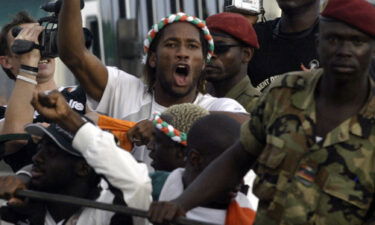 Drogba is seen aboard a military vehicle at Felix Houphouet Boigny airport in October 2005 after qualifying for the World Cup.