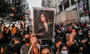 A protester holds a portrait of Mahsa Amini during a demonstration in Tehran on September 20.