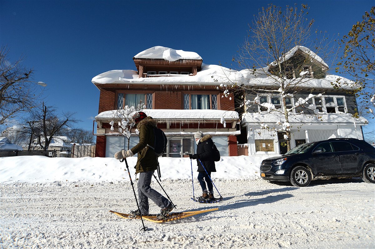 <i>John Normile/Getty Images</i><br/>People snowshoe through snow covered streets in Buffalo