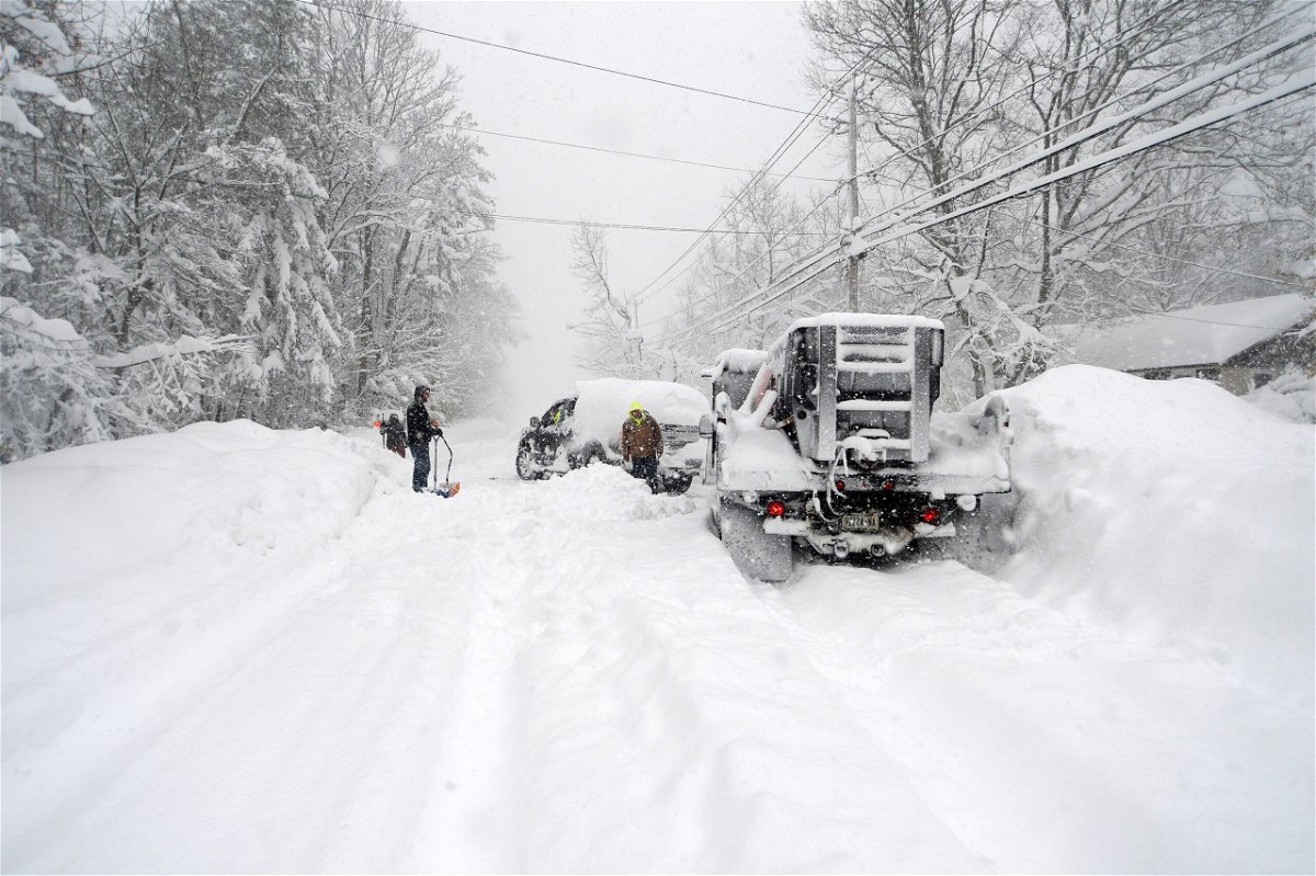 <i>John Normile/Getty Images</i><br/>Good Samaritans help dig out a plow Friday in Hamburg