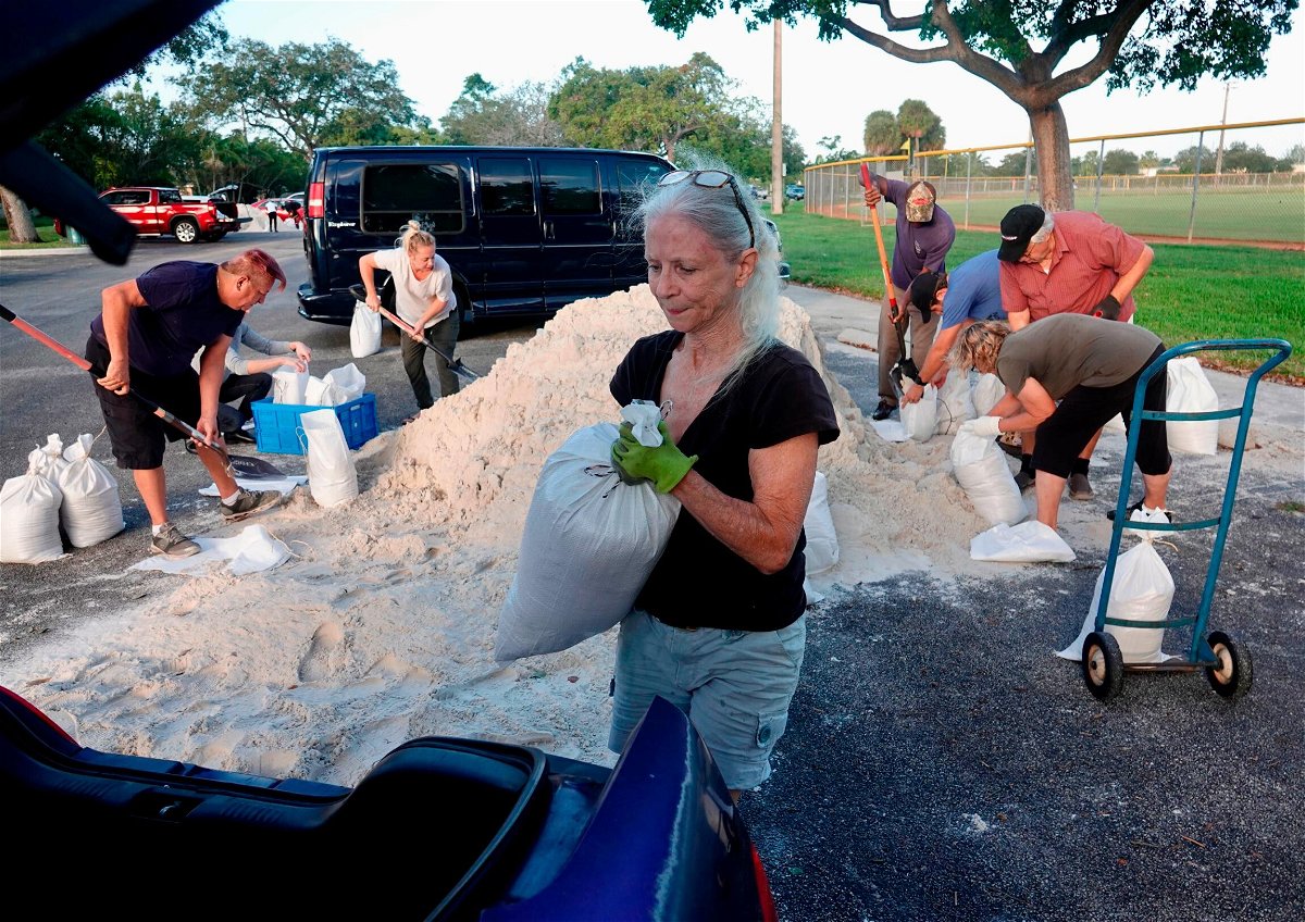 <i>Joe Cavaretta/AP</i><br/>Sandbags are distributed Tuesday at Mills Pond Park in Fort Lauderdale