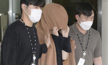 The mother appears in a New Zealand court over the alleged suitcase murders. She's seen here leaving a police station in Ulsan