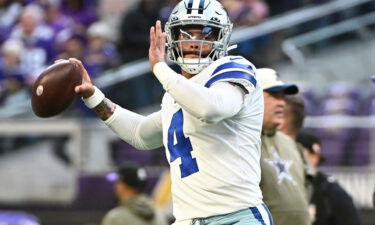 Cowboys QB Dak Prescott warms up prior to playing the Vikings.