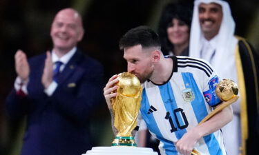 Lionel Messi kisses the World Cup trophy after receiving the Golden Ball award for best player of the tournament.