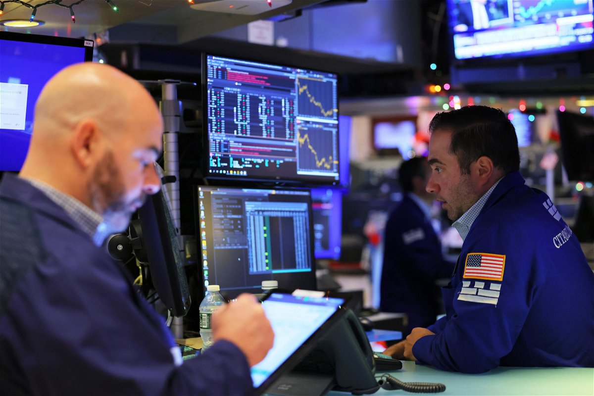 <i>Michael M. Santiago/Getty Images</i><br/>Traders work on the floor of the New York Stock Exchange during morning trading on December 6. Stocks sank Tuesday