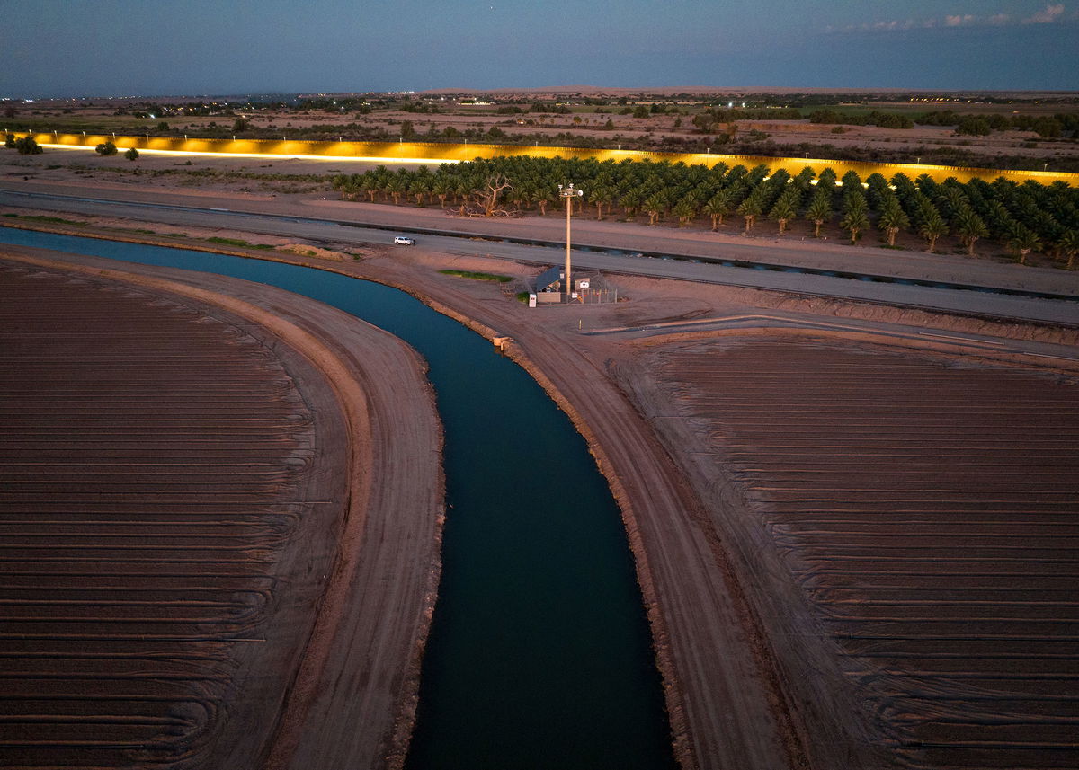 <i>John Moore/Getty Images</i><br/>The All-American Canal flows near a section of the US-Mexico border in September. The canal