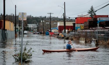 A person kayaks through Seattle's South Park neighborhood on Tuesday